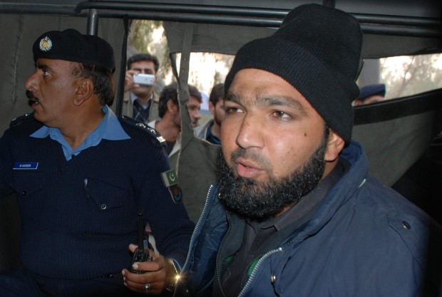 In this Tuesday, Jan. 4, 2011 file photo, commander of Pakistan's Elite force Mumtaz Qadri, right, who allegedly killed Punjab's governor Salman Taseer sits in police custody in Islamabad, Pakistan. Pakistan's Supreme Court on Wednesday, Oct. 7, 2015 has upheld the death sentence for a former police officer convicted of killing a provincial governor he had accused of blasphemy. Qadri shot and killed Governor Salman Taseer in 2011 in Islamabad days after Taseer defended a Christian woman accused of desecrating a Qur'an. (AP Photo/Irfan Ali, File)