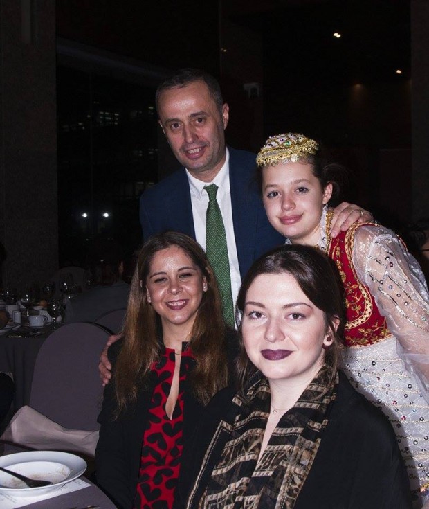 A family from Albania, the head of Albania Experience with his family, posing for a picture by Mr Lee. 