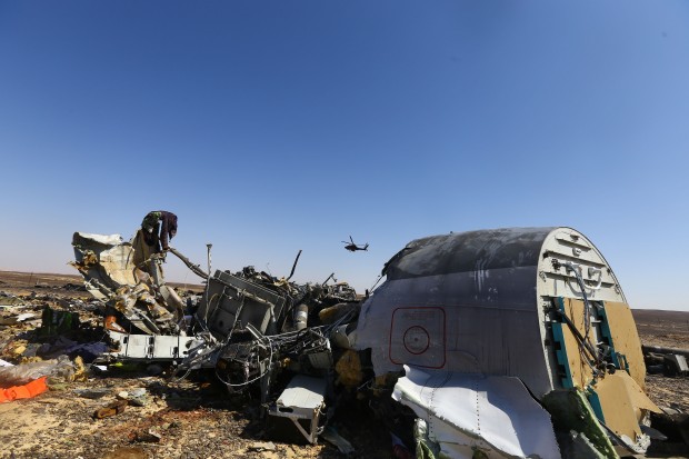 An Egyptian military helicopter flies over debris of a Russian passenger airplane which crashed at the Hassana area in Arish city, north Egypt, on November 1, 2015. Egyptian and international investigators on Sunday have begun probing the reasons of the Russian plane that crashed in Egypt's Sinai peninsula on Saturday which killed all 224 on board. (Xinhua/Ahmed Gomaa)
