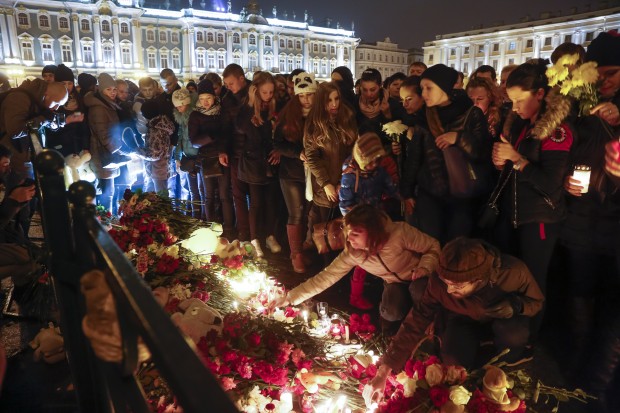 People light candles during a day of national mourning for the plane crash victims at Dvortsovaya (Palace) Square in St. Petersburg, Russia, on Sunday, Nov. 1, 2015. The Metrojet charter crashed Saturday morning 23 minutes after taking off from Egypt's Red Sea resort of Sharm el-Sheikh, a top destination for Russian tourists. All 224 people on board died.  (AP Photo/Dmitry Lovetsky)