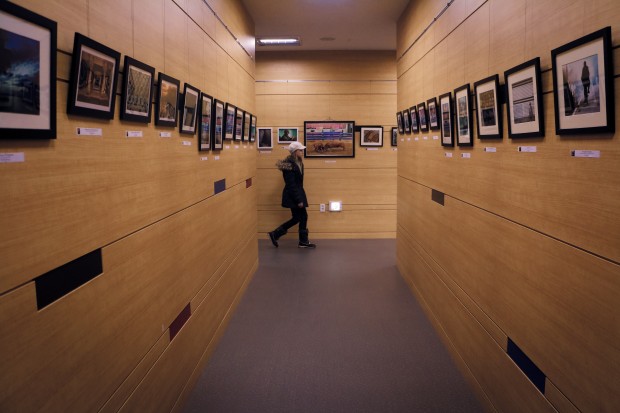 A visitor walks around the photo exhibition