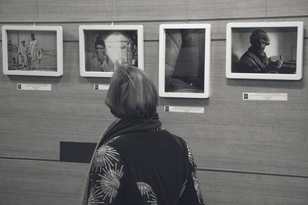 A visitor looks at the photographs at the exhibition.
