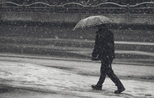 A man walks in the snow-covered streets in Hyehwa, Seoul.