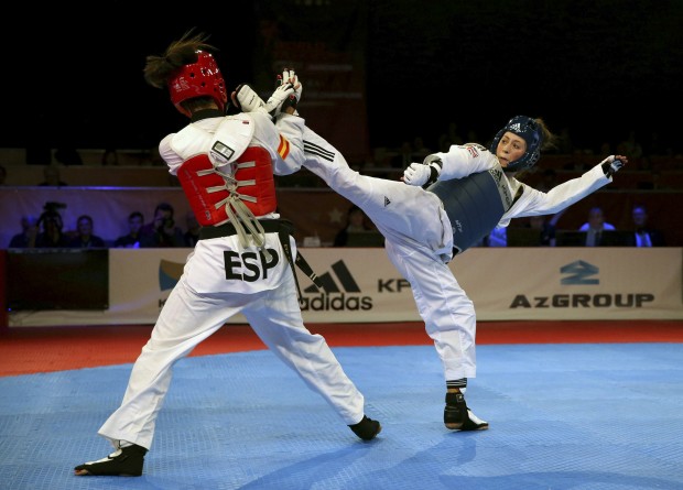 Great Britain's Jade Jones, right, in action against Spain's Eva Calvo Gomez during the Women's -57 final match during day two of the WTF World Taekwondo Championships at the Regional Arena Manchester, England, Saturday Oct. 17, 2015. (Simon Cooper/PA via AP)