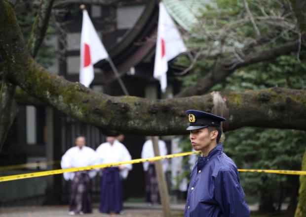 In this Monday, Nov. 23, 2015 file photo, a police officer stands guard Yasukuni Shrine in Tokyo following an explosion in its public restroom. Police in Tokyo have arrested a South Korean man suspected of causing an explosion last month at the controversial shrine in Tokyo that honors Japanese war dead. The 27-year-old Jeon Chang-han was arrested Wednesday, Dec. 9 after he returned to Tokyo from South Korea for voluntary questioning, police officials said. (AP Photo/Koji Sasahara)