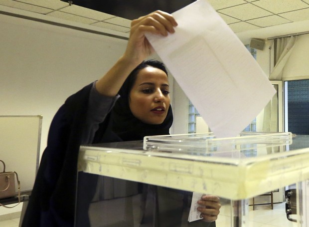A Saudi woman casts her ballot at a polling center during municipal elections in Riyadh, Saudi Arabia, Saturday, Dec. 12, 2015. Saudi women are heading to polling stations across the kingdom on Saturday, both as voters and candidates for the first time in this landmark election. (AP Photo/Aya Batrawy)