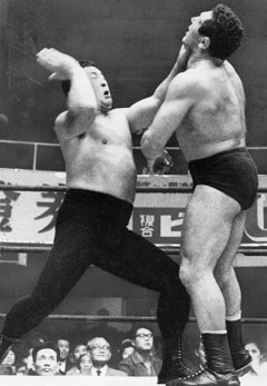 Rikidozan hitting a Mongolian chop on an opponent.
