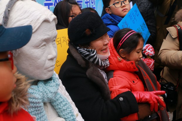 One of the former comfort women Lee Yong Soo, next to the white statue of the first comfort women to speak in public about sex slaves issue back in 1991, Kim Hak Soon, who died a few years ago.  (photo: Rahul Aijaz)
