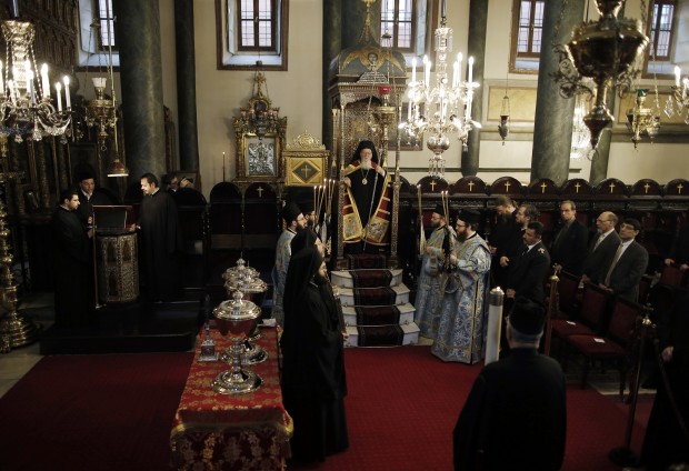 In Turkey, Ecumenical Patriarch Bartholomew I, the spiritual leader of the world's Orthodox Christians, center, during an Epiphany ceremony at the Patriarchate in Istanbul. The traditional Epiphany ceremony marks the Epithany in Istanbul when Bartholomew I or an Orthodox priest throws a simple wooden cross into the water to bless the water at the Golden Horn and swimmers race to be the first to retrieve it. (AP Photo/Emrah Gurel)