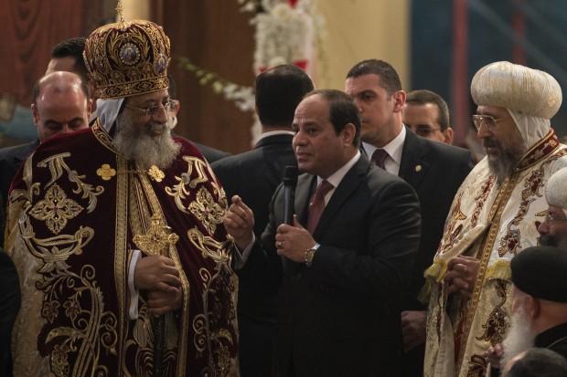 Egyptian President Abdel Fattah al-Sisi (C) speaks during the Coptic Orthodox Christmas Eve mass hosted by Pope Tawadros II (L) in St. Mark church in Cairo, Egypt. (Xinhua/Pan Chaoyue)