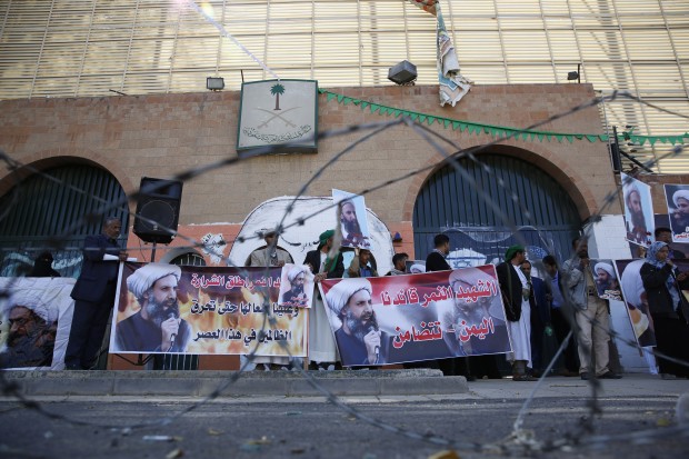 Shiite rebels, known as Houthis, hold posters of late Shiite cleric Nimr al-Nimr, who was executed in Saudi Arabia, during an anti-Saudi protest outside the Saudi embassy in Sanaa, Yemen, Thursday, Jan. 7, 2016. (AP Photo/Hani Mohammed)