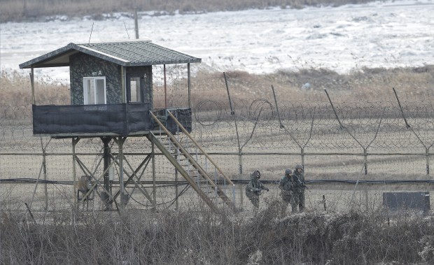 South Korean army soldiers patrol along the barbed-wire fence in Paju, near the border with North Korea, South Korea. North Korea has declared plans to launch an earth observation satellite later this month, an official with the London-based agency International Maritime Organization, said late Tuesday, Feb. 2, 2016. This satellite launch would cause international outrage because it is seen by the United Nations as a possible cover for a test of banned long-range missiles meant to further the Norths nuclear bomb and missile programs.(AP Photo/Ahn Young-joon)