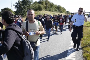 hundreds of refugees walk in Southern Jutland motorway near Padborg in Denmark. Danish police said Tuesday Feb. 16, 2016, that they have not seized any money or valuables from asylum-seekers since a contentious new law permitting them to do so came into force last month.  (AP Photo/POLFOTO, Martin Lehmann, File) DENMARK OUT