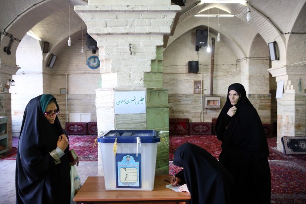 Iranian women vote in the parliamentary and Experts Assembly elections at a polling station in Qom, 125 kilometers (78 miles) south of the capital Tehran, Iran, Friday, Feb. 26, 2016. Polls opened Friday in Iran's parliamentary elections, the country's first since its landmark nuclear deal with world powers last summer.(AP Photo/Ebrahim Noroozi)