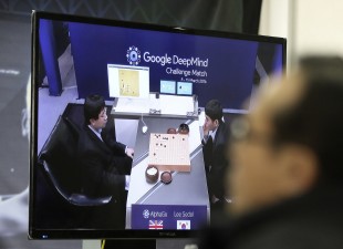 A man watches a TV screen showing the live broadcast of the Google DeepMind Challenge Match at Korea Baduk Association office in Seoul, South Korea, Wednesday, March 9, 2016. Computers eventually will defeat human players of Go, but the beauty of the ancient Chinese game of strategy that has fascinated people for thousands of years will remain, Go world champion Lee Sedol, right, said Tuesday. (AP Photo/Ahn Young-joon)