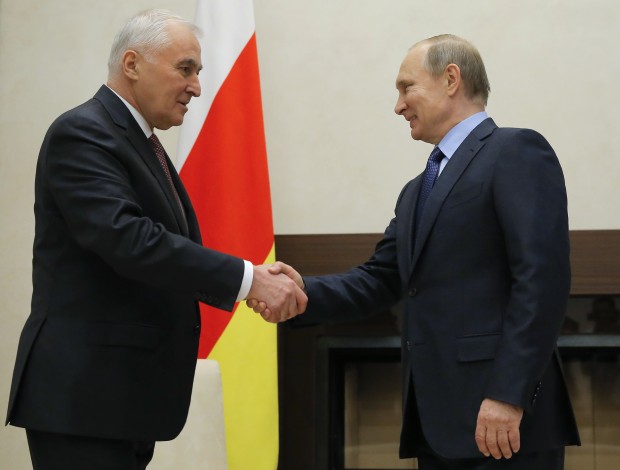 Russian President Vladimir Putin, right, shakes hands with Leonid Tibilov, President of the Georgian breakaway region of South Ossetia, at the Novo-Ogaryovo state residence outside Moscow, Russia, March 31, 2016. (Maxim Shipenkov/Pool photo via AP)