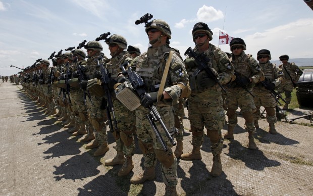 Georgian soldiers attend the opening ceremony of U.S, British and Georgian troops joint military exercises at the Vaziani military base outside Tbilisi, Georgia, Wednesday, May 11, 2016. About 1,300 U.S, British and Georgian troops are conducting joint exercises aimed at training the former Soviet republic's military for participation in the NATO Response Force. (AP Photo/Shakh Aivazov)