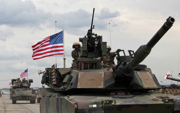 U.S servicemen drive their armored vehicles at the opening ceremony of U.S, British and Georgian troops joint military exercises at the Vaziani military base outside Tbilisi, Georgia, Wednesday, May 11, 2016. About 1,300 U.S., British and Georgian troops are conducting joint exercises aimed at training the former Soviet republic's military for participation in the NATO Response Force. (AP Photo/Shakh Aivazov)