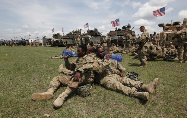 U.S. servicemen wait for the opening ceremony of U.S, British and Georgian troops joint military exercises at the Vaziani military base outside Tbilisi, Georgia, Wednesday, May 11, 2016. About 1,300 U.S., British and Georgian troops are conducting joint exercises aimed at training the former Soviet republic's military for participation in the NATO Response Force. (AP Photo/Shakh Aivazov)