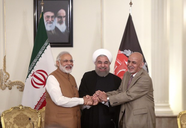 (160524) -- TEHRAN, May 24, 2016 (Xinhua) -- (From L to R) Indian Prime Minister Narendra Modi, Iranian President Hassan Rouhani and Afghan President Ashraf Ghani shake hands after their meeting at Saadabad Palace in Tehran, Iran, on May 23, 2016. Iran, India and Afghanistan signed a trilateral deal here on Monday to boost their regional trade and economic cooperation. The agreement, signed in the presence of Iranian President Hassan Rouhani, Indian Prime Minister Narendra Modi and Afghan President Ashraf Ghani, is to develop Iran's Chabahar port, which would serve as a transit route connecting the three countries. (Xinhua/Ahmad Halabisaz)