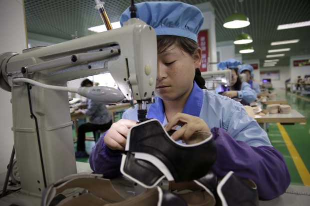 June 22, 2016, photo, a factory worker operates a sewing machine at a shoe factory in Wonsan, North Korea. For the past few weeks, North Koreans across the nation have been mobilized for a 200-day "speed campaign" in line with their leader Kim Jong Un's vows to raise the nation's standard of living and energize his new five-year plan to develop the economy. At the direction Kim Jong Un, who visited the factory last November, workers are now focusing on making lighter, better quality shoes and providing a wider variety to make North Korea's shoe production "world class" before the five-year plan ends. (AP Photo/Wong Maye-E)