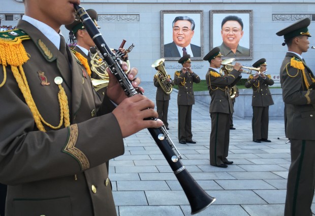 North Korean military band members play their instruments in front of portraits of the late North Korean leaders Kim Il Sung and Kim Jong Il during an anti-U.S. rally attended by thousands of North Koreans to mark the 66th anniversary of the start of the Korean War at the Kim Il Square on Saturday, June 25, 2016, in Pyongyang, North Korea. (AP Photo/Wong Maye-E)