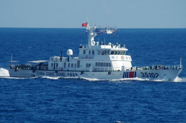 In this photo released by the 11th Regional Coast Guard Headquarters of Japan, a Chinese coast guard vessel sails near disputed East China Sea islands Saturday, Aug. 6, 2016. Japan's Foreign Ministry said in a statement it filed the protest after Japan's coast guard spotted the vessels Saturday along with a fleet of 230 Chinese fishing boats swarming around the Japanese-controlled Senkaku Islands. China also claims the islands, calling them the Diaoyu. (11th Regional Coast Guard Headquarters via AP)