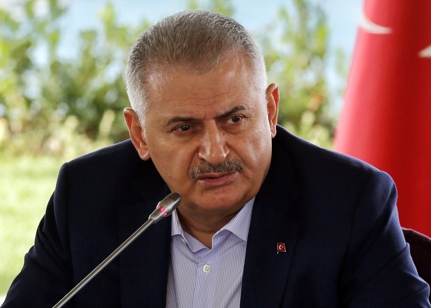 Turkish Prime Minister Binali Yildirim speaks during a meeting with foreign media representatives in Istanbul, Saturday, Aug. 20, 2016. Yildirim says his country is willing to accept a role for Syrian President Bashar Assad during a transitional period in Syria. (Prime Minister Press Service via AP)