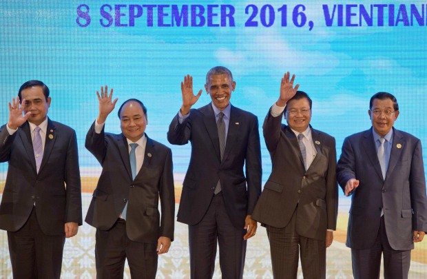 U.S. President Barack Obama, center, waves with leaders of the Association of Southeast Asian Nations (ASEAN) during  ASEAN-U.S. summit, a parallel summit in the ongoing 28th and 29th ASEAN Summits and other related summits at National Convention Center in Vientiane, Laos, Thursday, Sept. 8, 2016. ASEAN leaders from left, are Thailand's Prime Minister Prayuth Chan-ocha, Vietnamese Prime Minister Nguyen Xuan Phuc, Laos' Prime Minister Thongloun Sisoulith and Cambodia's Prime Minister Hun Sen. (AP Photo/Gemunu Amarasinghe)