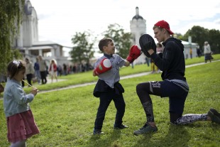 A boy takes boxing lessons during celebrations marking the Day of the City in a park in Moscow, Russia, on Saturday, Sept. 10, 2016. Moscow's official history marks 869th anniversary today. (AP Photo/Ivan Sekretarev)