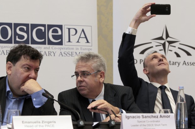 Emanuelis Zingeris, a head of the PACE Delegation, left, Ignacio Sanchez Amor, a leader of the OSCE Short Term Observers, and Guglielmo Picchi, Head of the OSCE Parliamentary Assembly Delegation, right, attend a news conference after the parliamentary election in Tbilisi, Georgia, Sunday, Oct. 9, 2016. Georgia's governing party, which has pursued both closer ties with the West and improved relations with Russia, was strongly in the lead Sunday after votes for its parliamentary election were counted from more than 80 percent of the country's precincts. (AP Photo/Shakh Aivazov)
