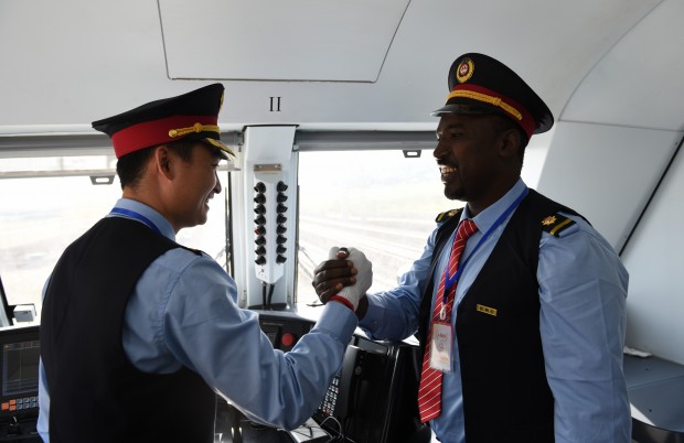 ADDIS ABABA, Oct. 6, 2016 (Xinhua) -- Chinese train driver Liu Ji (L) and his Ethiopian colleague Geto shake hands before the inauguration ceremony of the Addis Ababa-Djibouti railway in Addis Ababa, Ethiopia, on Oct. 5, 2016. Ethiopia and Djibouti on Wednesday launched Africa's first modern electrified railway connecting their capitals, with officials hailing the Chinese-built rail as the latest testament to the Sino-African friendship. The 752.7-km Ethiopia-Djibouti railway, also known as Addis Ababa-Djibouti railway, was inaugurated in the Ethiopian capital in a grand ceremony. (Xinhua/Li Baishun)(zhf)