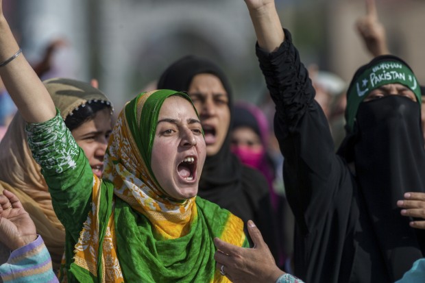 Kashmiri Muslims women shout pro-freedom slogans during the funeral procession of Junaid Ahmed, a 12-year-old boy in Srinagar, Indian-controlled Kashmir, Saturday, Oct. 8, 2016. Indian forces fired shotgun pellets and tear gas Saturday as thousands carried the body of the boy killed overnight during an anti-India protest in the main city of Indian-controlled Kashmir. (AP Photo/Dar Yasin)