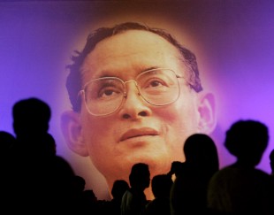 FILE - In this June 10, 2006, file photo, an image of Thailand's King Bhumibol Adulyadej is projected during an exhibition in Bangkok. Thailand's Royal Palace said on Thursday, Oct. 13, 2016, that King Bhumibol, the world's longest-reigning monarch, has died at age 88. (AP Photo/Apichart Weerawong, File)