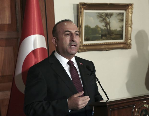 Turkey's Foreign Minister Mevleut Cavusoglu talks to the media during a joint news conference with his French counterpart Jean-Marc Ayrault in Ankara, Turkey, Monday, Oct. 24, 2016. Cavusoglu says the country is contributing to the ongoing Mosul operation in a "multifaceted way." (AP Photo/Burhan Ozbilici)