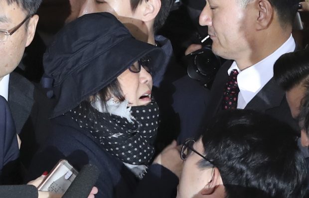 Choi Soon-sil, center left, a cult leader's daughter with a decades-long connection to President Park Geun-hye, is surrounded by prosecutor's officers and media upon her arrival at the Seoul Central District Prosecutors' Office in Seoul, South Korea, Monday, Oct. 31, 2016. South Korea is hoping for answers Monday about its biggest scandal in years. At the center is Choi Soon-sil. Media speculation claims that Choi, who has no official ties to the administration, may have had a major role in government affairs by pulling strings from the shadows while exploiting her relationship with Park for money and favors. (AP Photo/Lee Jin-man)