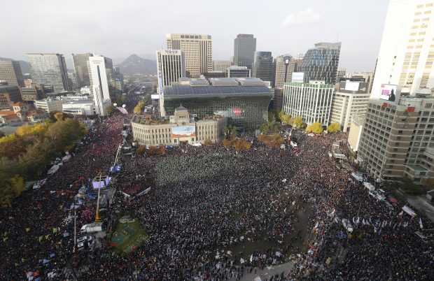 Protesters stage a rally calling for South Korean President Park Geun-hye to step down in Seoul, South Korea, Saturday, Nov. 12, 2016. Tens, and possibly hundreds, of thousands of South Koreans were expected to rally in Seoul on Saturday demanding the ouster of Park in what would be one of the biggest protests in the country since its democratization about 30 years ago. (AP Photo/Ahn Young-joon)