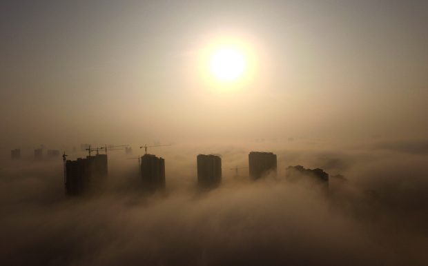RIZHAO, Nov. 14, 2016 (Xinhua) -- Photo taken on Nov. 14, 2016 shows buildings shrouded in fog in Rizhao, east China's Shandong Province. The National Meteorological Center (NMC) issued an orange warning for heavy fog in east and central China on Monday. (Xinhua/Liu Mingzhao)(wyo)