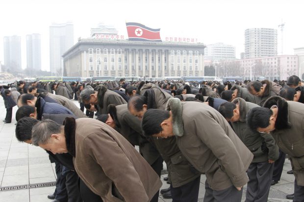 People bow to portraits of the late leaders, Kim Il Sung and Kim Jong Il, at the Kim Il Sung Square in Pyongyang, North Korea, Saturday, Dec. 17, 2016, to mark the fifth anniversary of Kim Jong Il's death. It’s been five years since North Korean leader Kim Jong Un took power following the death of his father, Kim Jong Il, whose demise was observed at monuments and on city center plazas across the nation Saturday. (AP Photo/Kim Kwang Hyon)