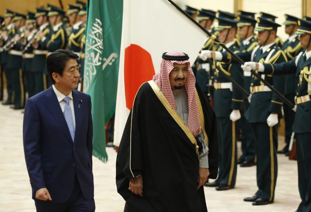 Saudi King, right, and Japan's Prime Minister Shinzo Abe review an honor guard before their meeting at Abe's official residence in Tokyo Monday, March 13, 2017. King Salman and hundreds of business leaders from Saudi Arabia are in Japan for talks Monday mainly expected to focus on economic ties. (Toru Hanai/Pool Photo via AP)