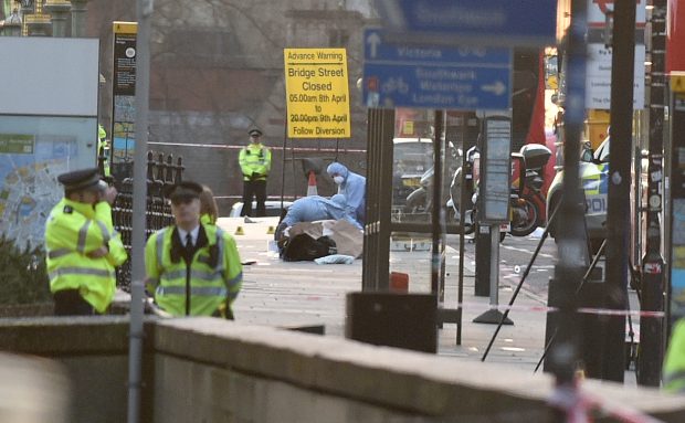 (170322) -- LONDON, March 22, 2017 (Xinhua) -- Emergency services staff and forensic officers work on Westminster Bridge in London, Britain on March 22, 2017. Four people have been killed, including the stabbed officer and a male terrorist, and at least 20 injured in an attack on the Houses of Parliament Wednesday afternoon in a terrorist attack, police announced. (Xinhua/Tim Ireland)