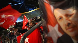 (FILES) This file photo taken on February 18, 2017 shows people waving Turkish flags during an event with the Turkish prime minister to promote a constitutional referendum in Oberhausen, western Germany.
German Chancellor Angela Merkel on March 20, 2017 warned that Germany could ban future campaign events by Turkish politicians on its soil unless Ankara stopped "Nazi" jibes aimed at Berlin.  / AFP PHOTO / Sascha Schuermann
