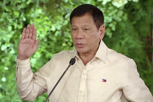In this image made from video provided by Radio Television Malacanang, new Philippine President Rodrigo Duterte takes the oath during the inauguration ceremony in Malacanang Palace, Thursday, June 30, 2016 in Manila, Philippines. Duterte was sworn in Thursday as president of the Philippines, with many hoping his maverick style will energize the country, but others fearing he could undercut one of Asia's liveliest democracies amid his threats to kill criminals en masse. (Radio Television Malacanang via AP Video)