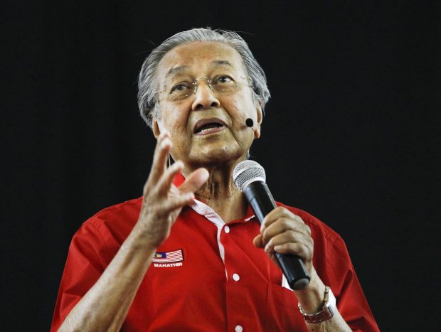 FIEL - In this Aug. 13, 2017, file photo, former Malaysian Prime Minister Mahathir Mohamad speaks during a forum in Shah Alam, Malaysia. Malaysia's opposition alliance has named 92-year-old former Prime Minister Mahathir as its prime minister candidate for general elections to boost its chances of wrestling power from a coalition that has ruled since independence. (AP Photo/Daniel Chan, File)