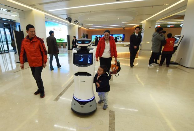 Residents are guided by AI robot Xiaotu in the New Service Center in Hangzhou Xiaoshan District on January 2. Long Wei from People’s Daily Online