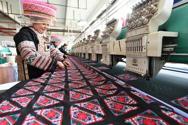 Women in Yangchuan Industrial Park, Suiyang county, Zunyi of southwest China’s Guizhou province make embroidery pieces, March 16, 2019. In recent years, the development of hand-embroidered products in the county has become a major measure for rural women to get rid of poverty. The traditionally pure manual work has been transformed into semi-mechanized and large-scale production, with a variety of new products popular in the market introduced, including embroidered medicine pillows, embroidered medicine pads, and sachets. (Photo from People’s Daily Online)