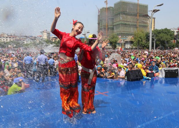 People celebrate the Water-Splashing Festival at a square in Jinghong, southwest China’s Yunnan province, April 15, 2018. (Photo/People’s Daily Online)