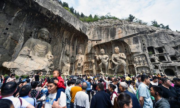 Photo taken on May 4, 2019 shows tourists visit the Longmen Grottoes in Luoyang, central China’s Henan province. Longmen Grottoes is a UNESCO World Heritage Site and a high point of Chinese stone carving. Photo: People’s Daily Online