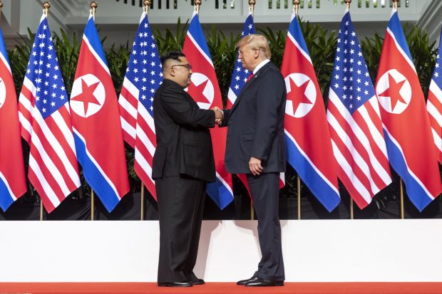 kim_and_trump_shaking_hands_at_the_red_carpet_during_the_dprk-usa_singapore_summit