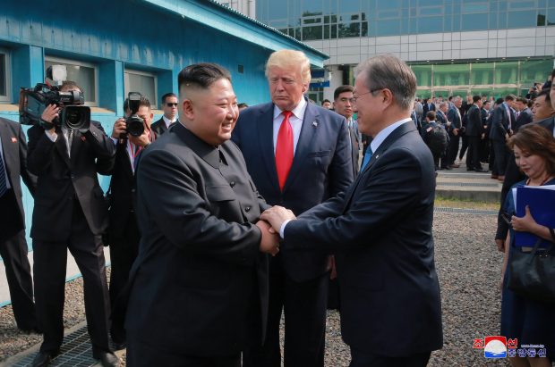 epa07686298 A photo released by the official North Korean Central News Agency (KCNA) shows US President Donald J. Trump (C) watching as North Korean leader Kim Jong-un (C-L) and South Korean President Moon Jae-in (C-R) shake hands in the truce village of Panmunjom in the Demilitarized Zone, which separates the two Koreas, 30 June 2019. The US leader arrived in South Korean on 29 June for a two-day visit that will include a meeting with South Korean President Moon Jae-in and a trip to the Demilitarized Zone.  EPA/KCNA   EDITORIAL USE ONLY